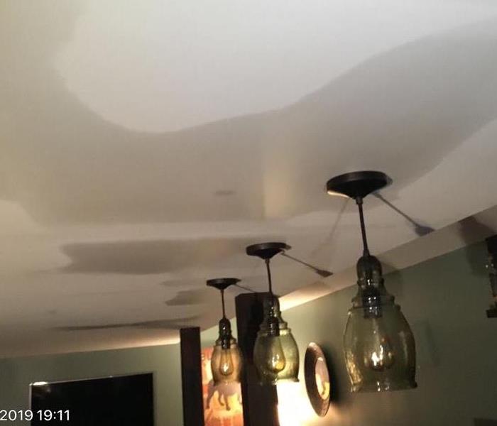 This image shows the water damage done to the ceiling of a homeowners basement